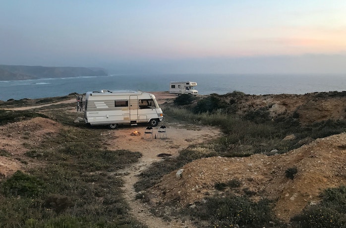 An RV on a cliff top looking out over ocean
