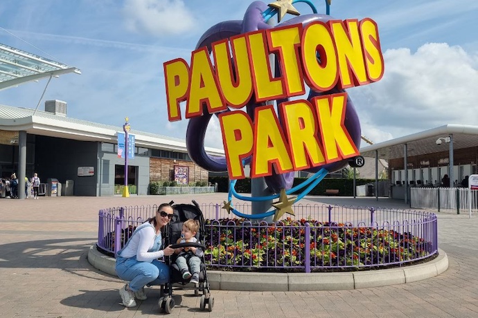 Mum and son in front of Paultons sign