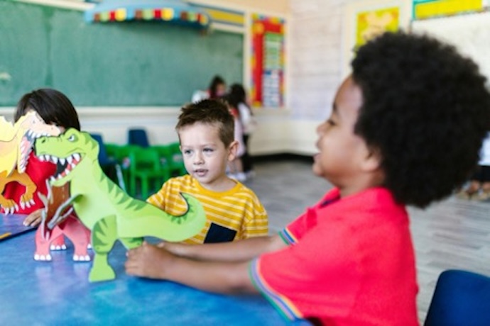 Preschoolers playing with dinosaurs