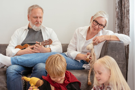 a grandad plays banjo with kids